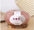 DIY mohair scarf weaving kit showing one wool ball and a selection of 34 colour options including white, pink, blue and green.