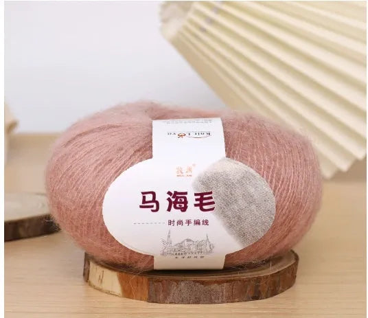 DIY mohair scarf weaving kit showing one wool ball and a selection of 34 colour options including white, pink, blue and green.