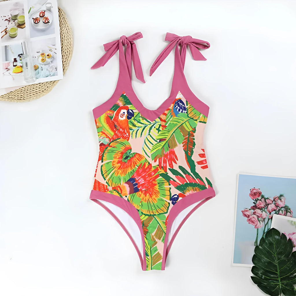 Women's pink floral print one-piece swimsuit with V-neck and a separate cover-up skirt.