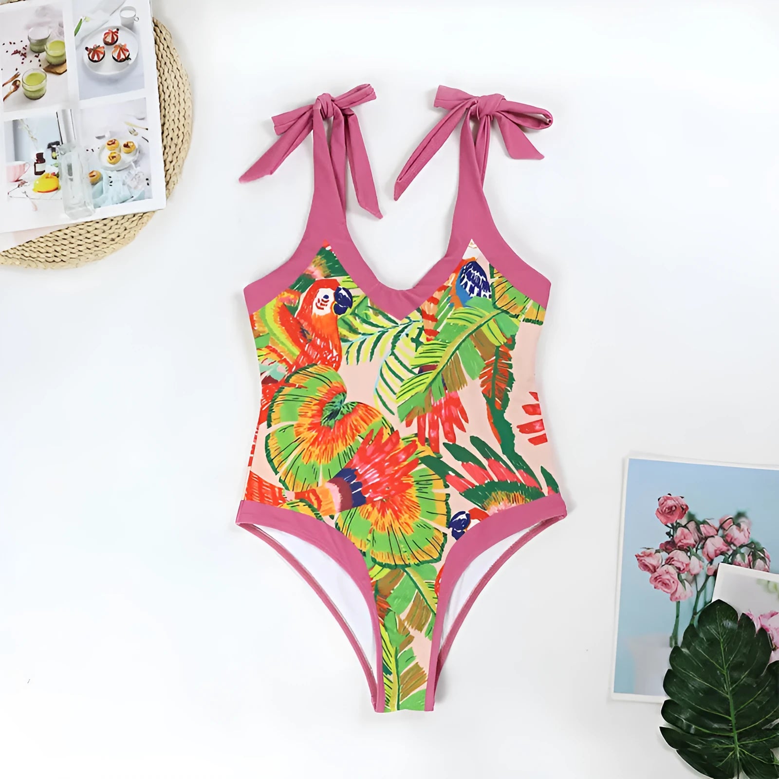 Women's pink floral print one-piece swimsuit with V-neck and a separate cover-up skirt.