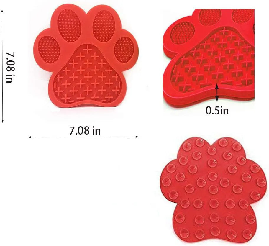 Blue silicone dog licking mat with bone texture and suction cups on the back, placed on a tiled wall.