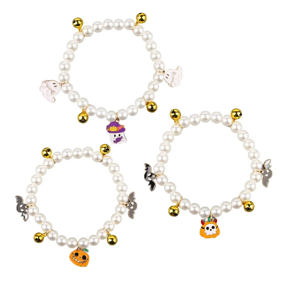Purple simulated pearl cat collar with three Halloween pumpkin charms: ghost, skull, and smiley face.