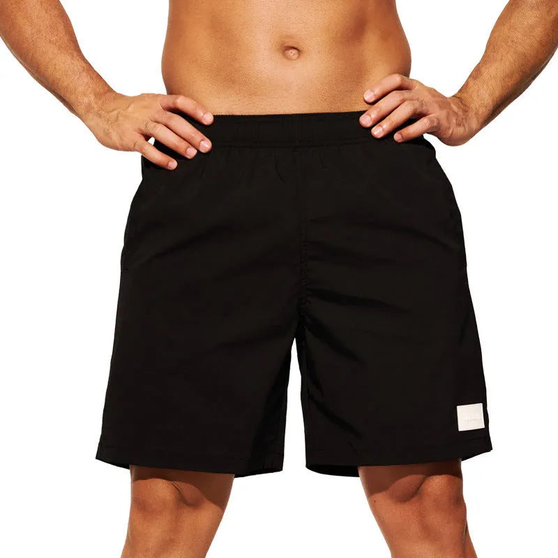 Men's quick-dry nylon sports shorts in solid colours with straight leg design