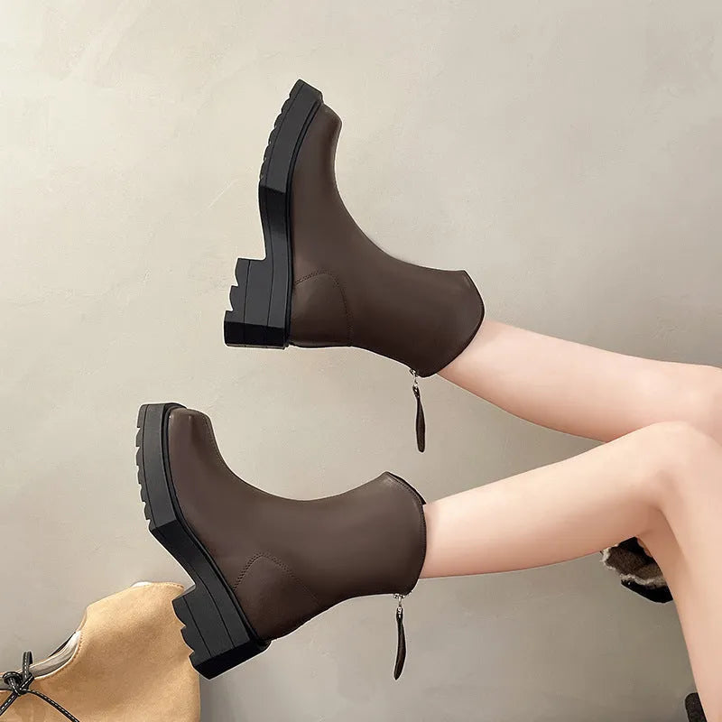 Women's black platform Martin boots with square toe, chunky heel, and back zipper on a white background.