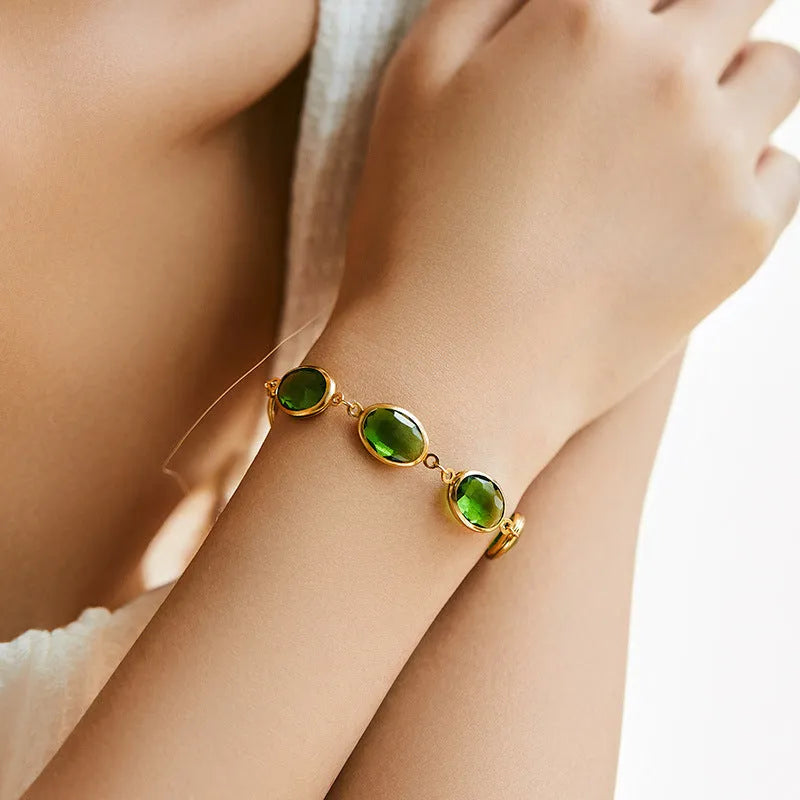 Women's 18K copper geometric ellipse bracelet with blue green multicolor glass inlay detailing