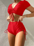 Women's lace-up swimsuit top with matching shorts in dark green colour