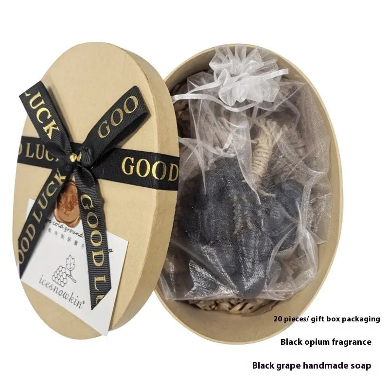 Handmade grape soap bars in black, green, and purple grape scents alongside litchi soap, with gift box and mesh bag packaging