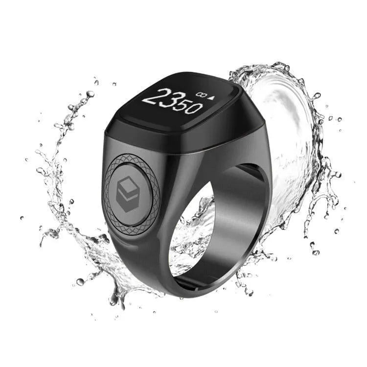Zikr1 smart ring showing OLED display with time and count, metal body, on a finger.