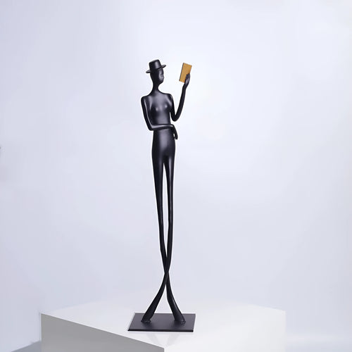 Black metal cast aluminium sculpture of reading woman on square base