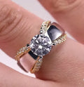 KYRA0702 two-tone geometric women's ring in brass and white steel on a grey background.