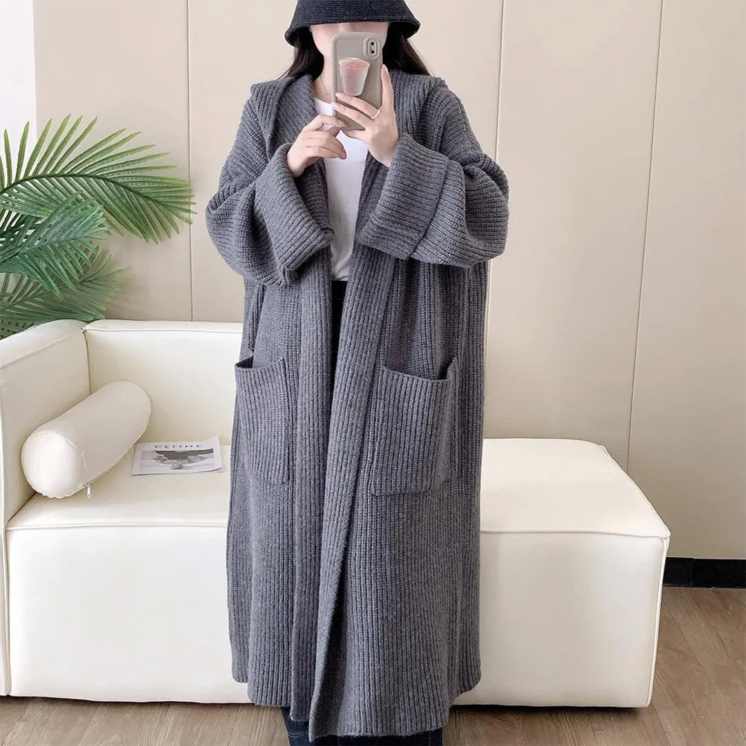 Loose hooded acrylic cardigan coat for women in beige, showing long length and raglan sleeves.