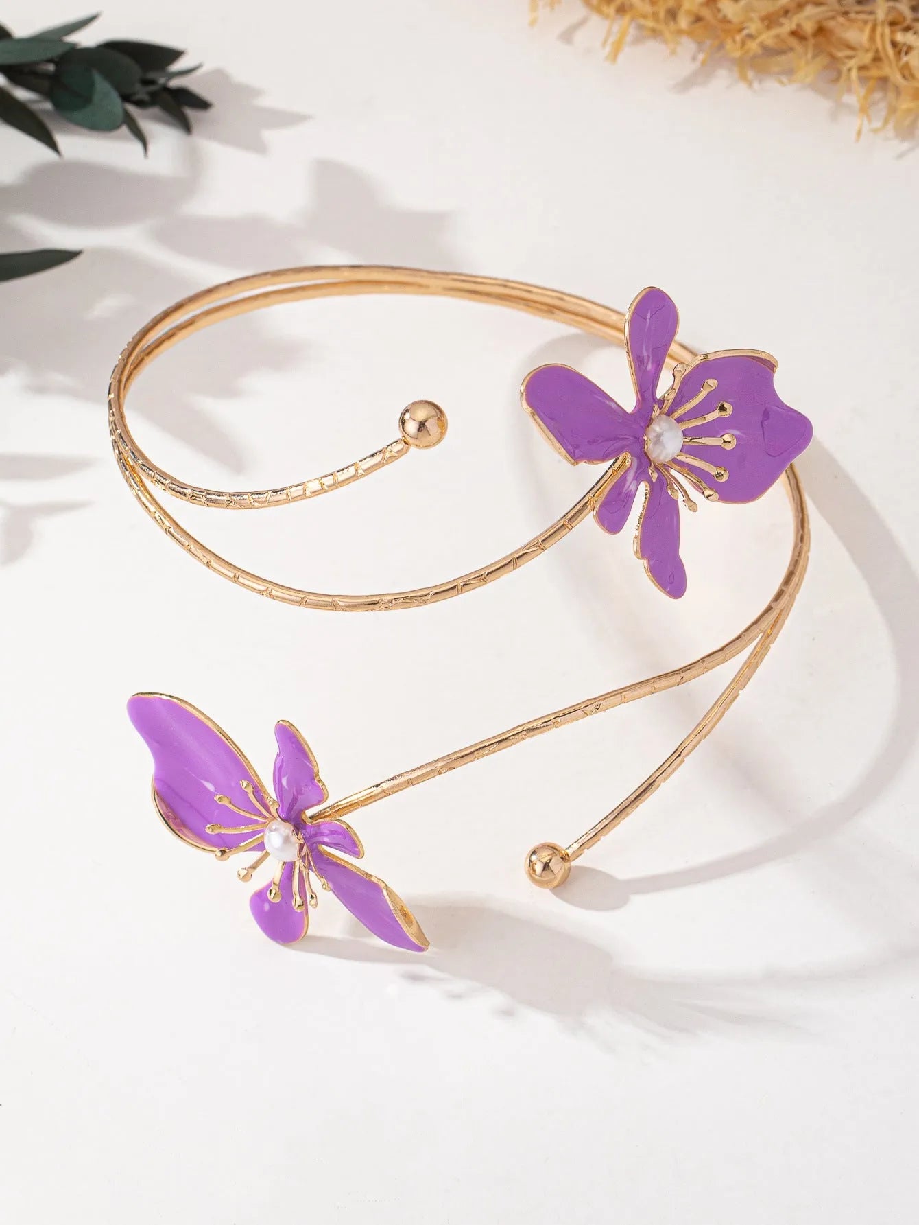 Pink alloy armband with hollow pattern design showing adjustable sizing and cut-out details