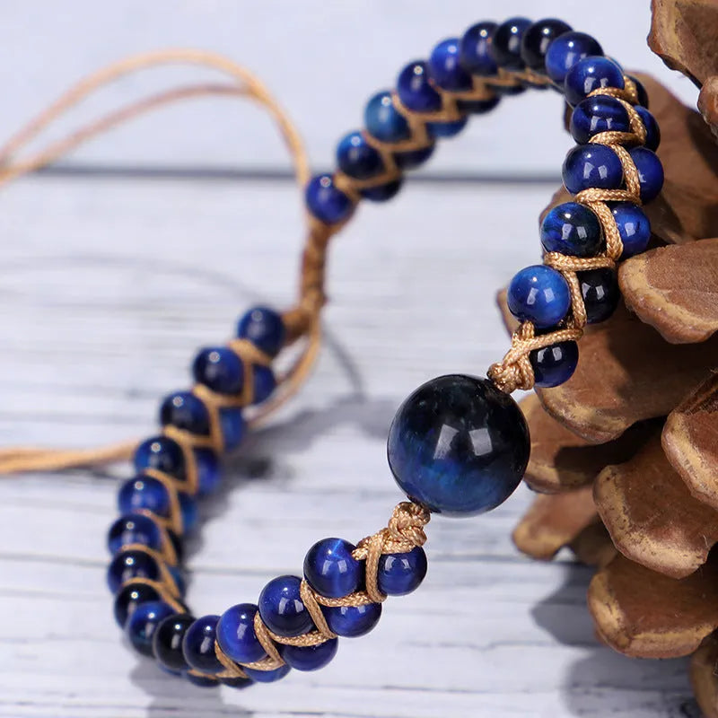 Handmade woven geometric bracelet with a blue Tigereye stone bead and pull design.