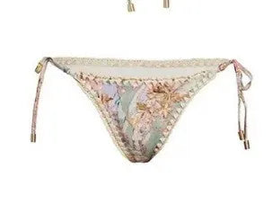 Women's creamy-white floral bikini swimsuit set with skirt, top, and briefs in nylon fabric