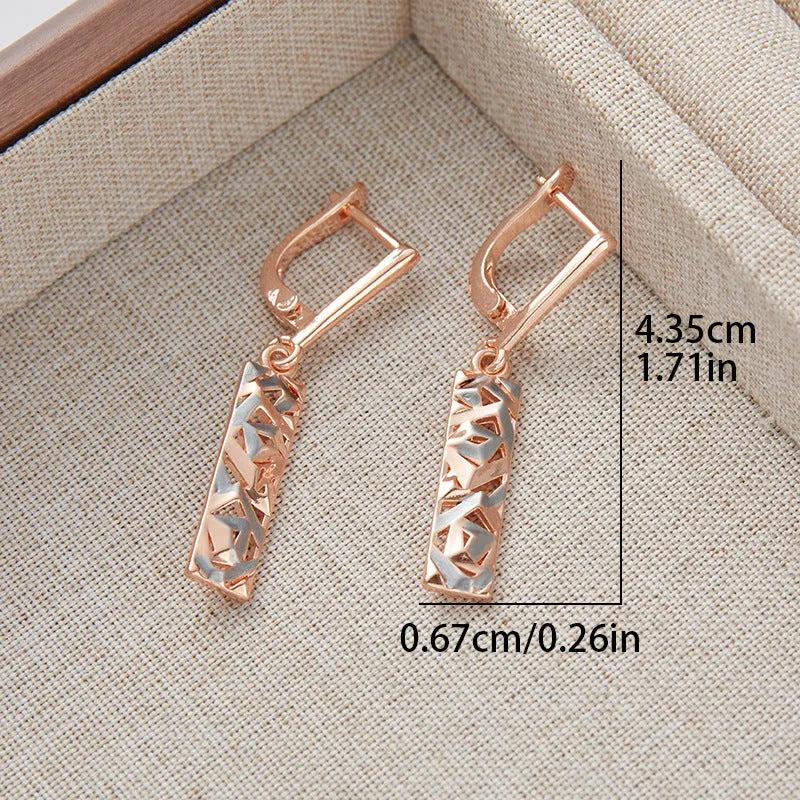 Close-up of women's rectangular hollow two-tone alloy stud earrings on a white background.