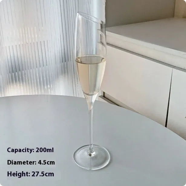 A single clear French goblet champagne glass on a table.