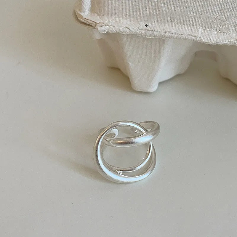 Geometric interlaced matte metal open ring for women in gold or silver.