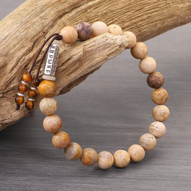 Handmade stone bead bracelet in wood colour on a simple background, showing retro style design.