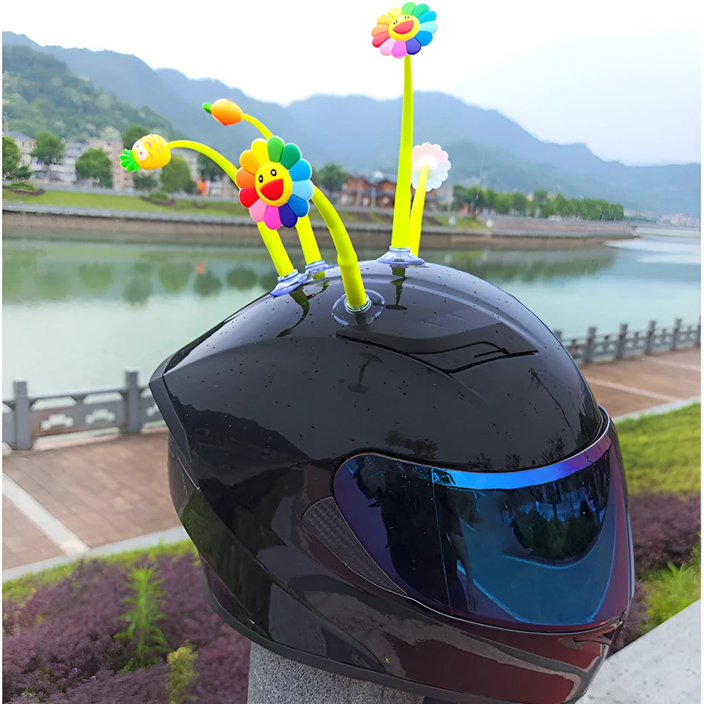 Yellow silicone sunflower decoration with suction cup for attaching to a helmet.