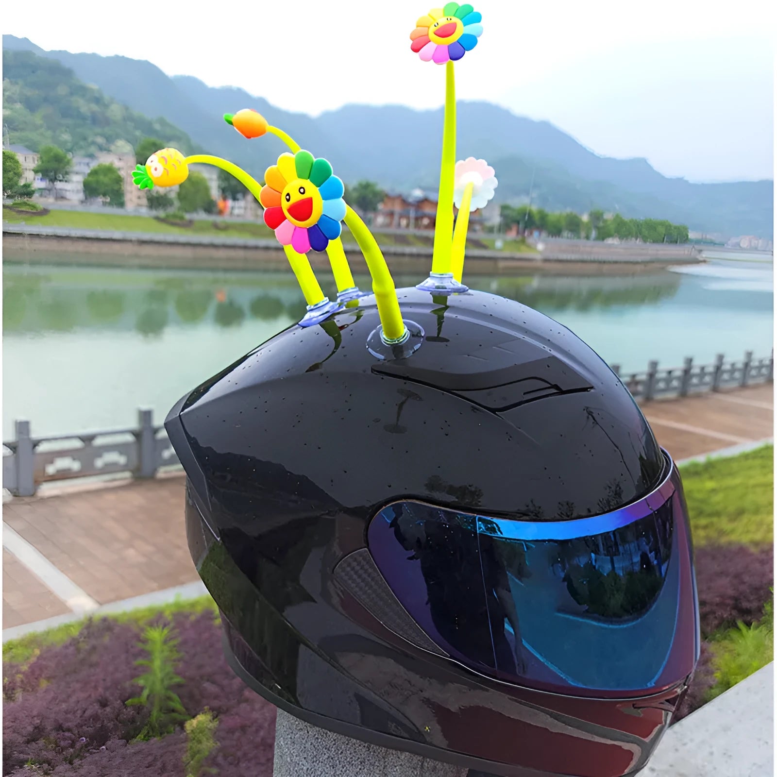 Yellow silicone sunflower decoration with suction cup for attaching to a helmet.