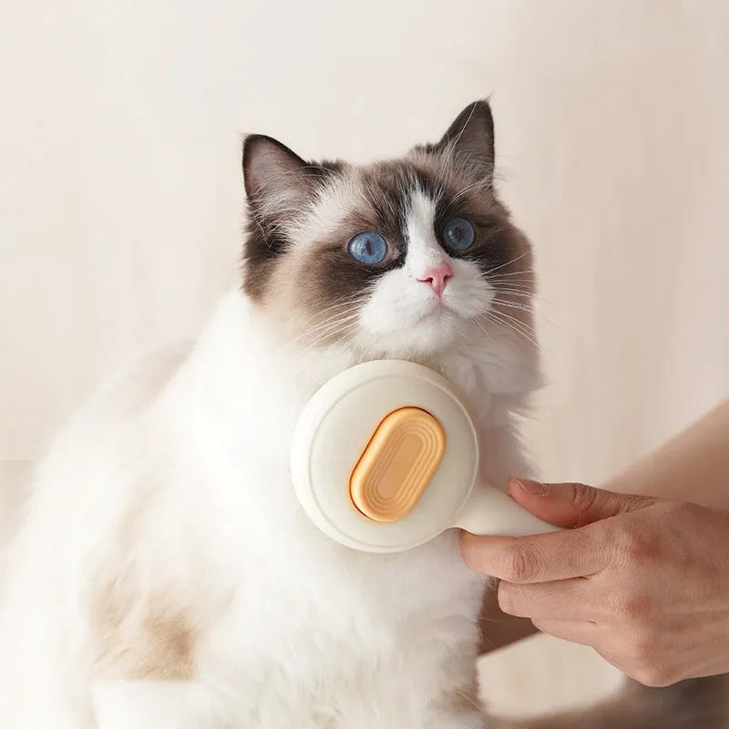 Green and yellow plastic cat brush with stainless steel teeth and a non-slip handle.
