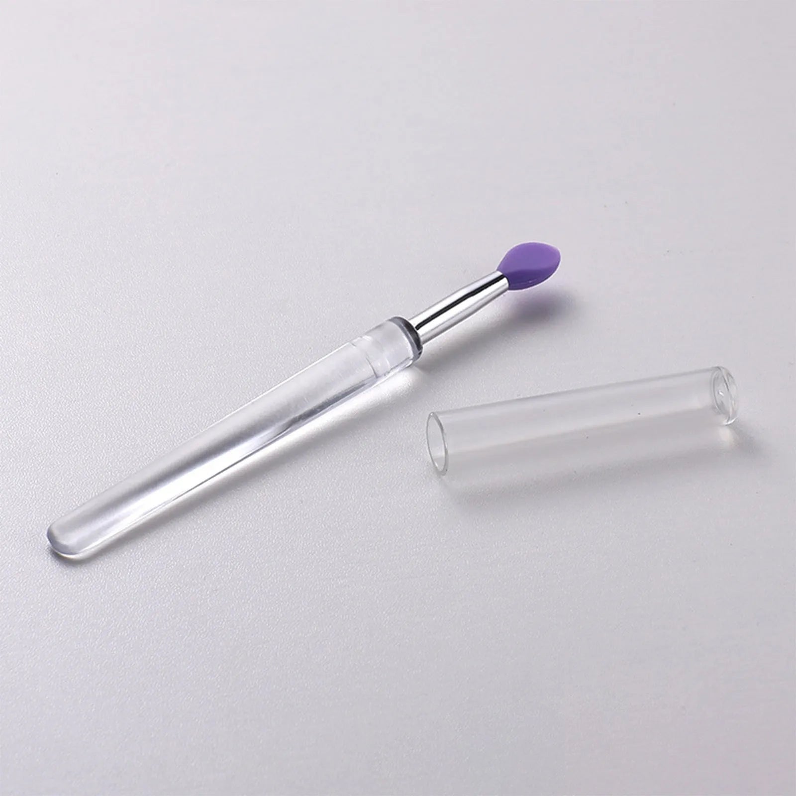 Set of silicone lip brushes with caps in various colours including blue, pink, and purple.
