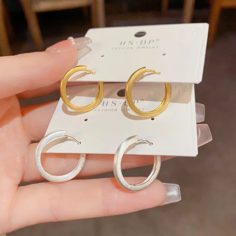 Geometric round ear clip jewellery with gold plating in minimalist style