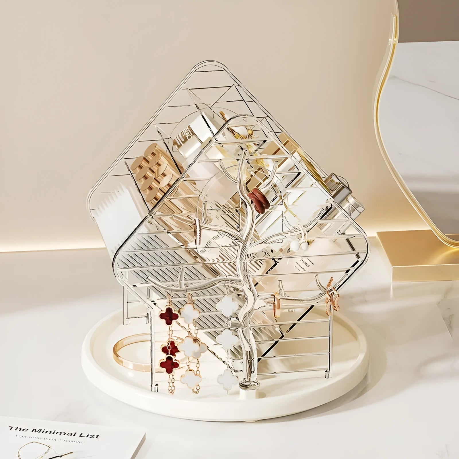 Clear and amber gold rotating cosmetics storage box organiser on a table.