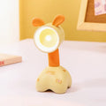 DIY cartoon animal magnetic night lamp in assorted colours on a desk, with adjustable lamp head.