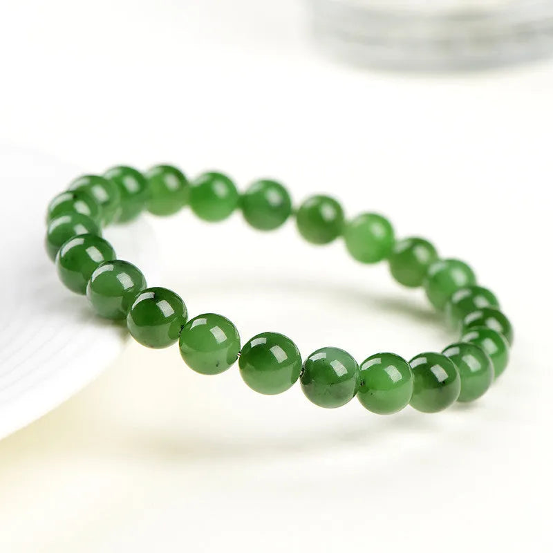 Polished Hetian jade jasper ball bracelet showing natural stone beads in multiple size options on a wrist.