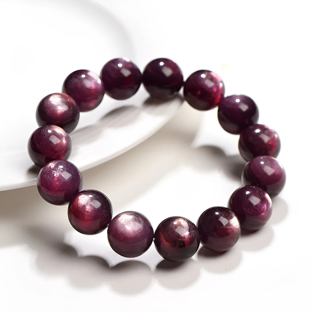 Natural purple lepidolite round bead crystal bracelet showing polished beads on a wrist.