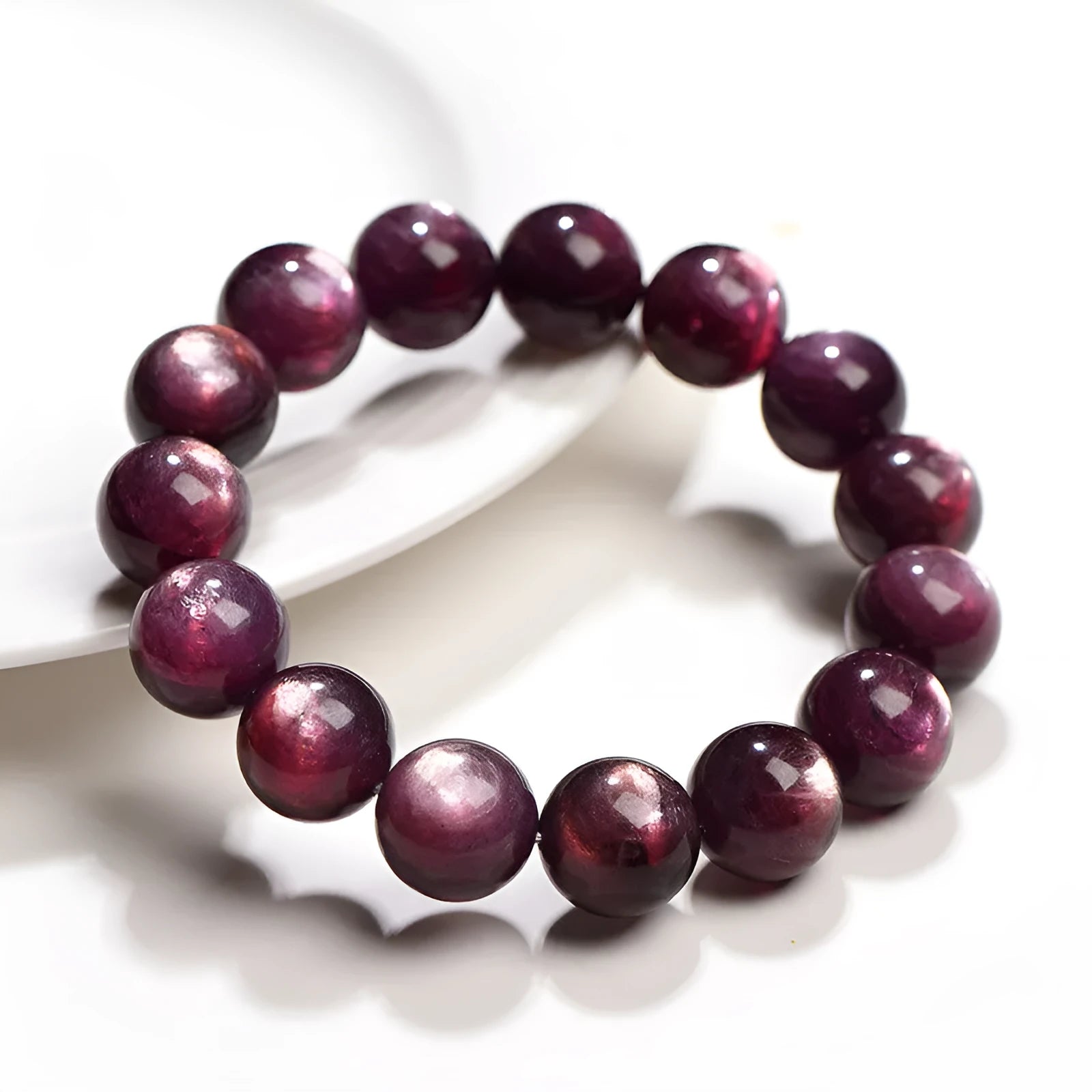 Natural purple lepidolite round bead crystal bracelet showing polished beads on a wrist.