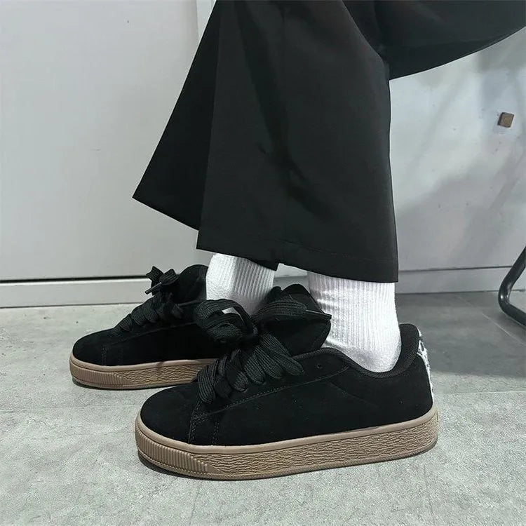 Black retro-style low-top lace-up sneakers with a round toe and waterproof platform sole.