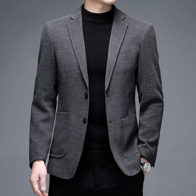 Men's loose fit wool suit jacket in solid colour showing round hem design and long sleeves