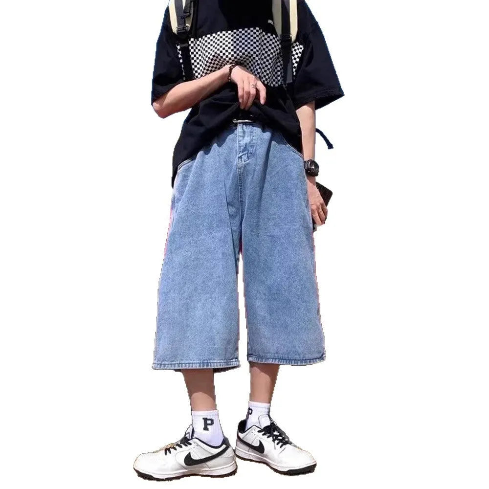 Blue washed denim shorts for men with high waist and cropped pirate-style legs on a plain background.