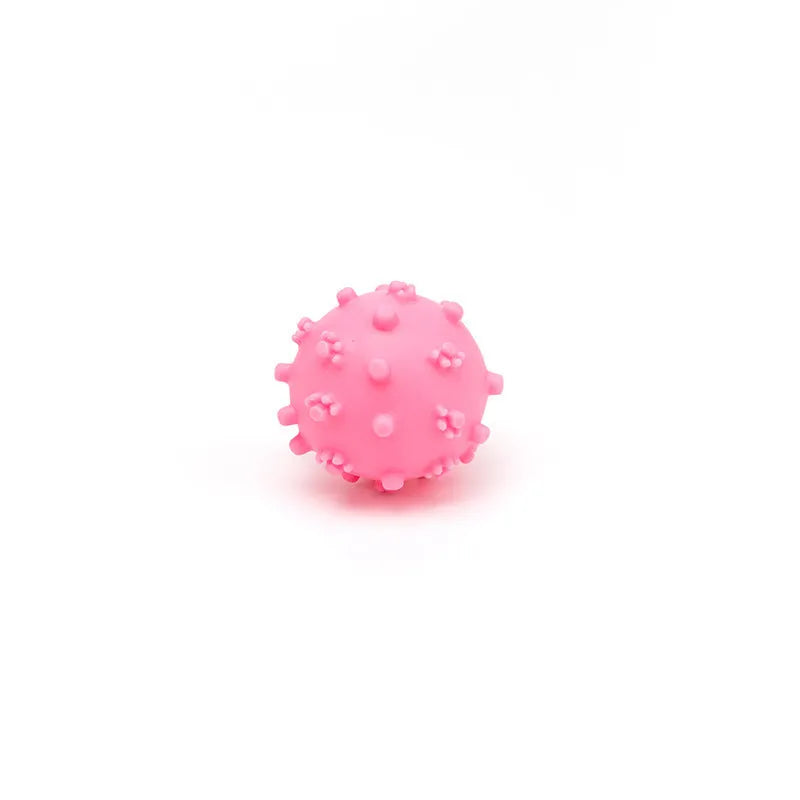 Bright blue, green, pink, and yellow spiky dog balls for small puppy teething and play.