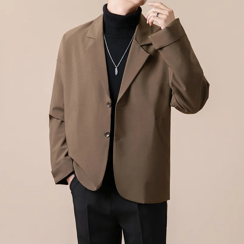 Man wearing a loose fit casual suit jacket in a light business style, available in apricot colour.