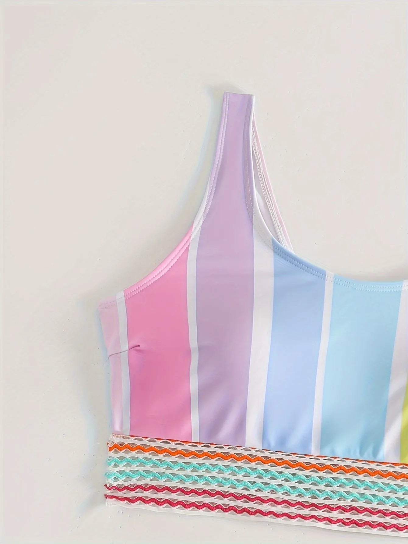 Women's striped blue and white sports bikini set on a mannequin