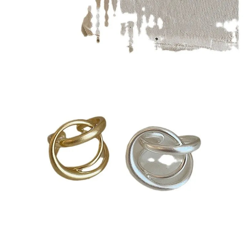 Geometric interlaced matte metal open ring for women in gold or silver.