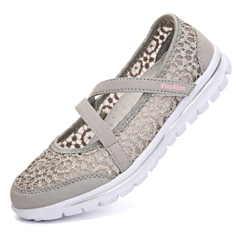 Women's flat casual shoes in beige with mesh upper and round toe, shown from the side.