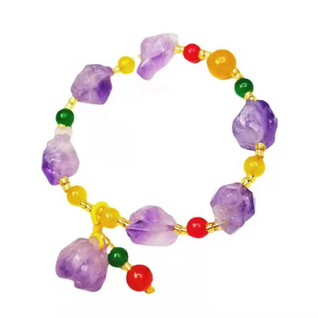 Women's amethyst bracelet with natural shaped beads and a fu character charm on an adjustable band.