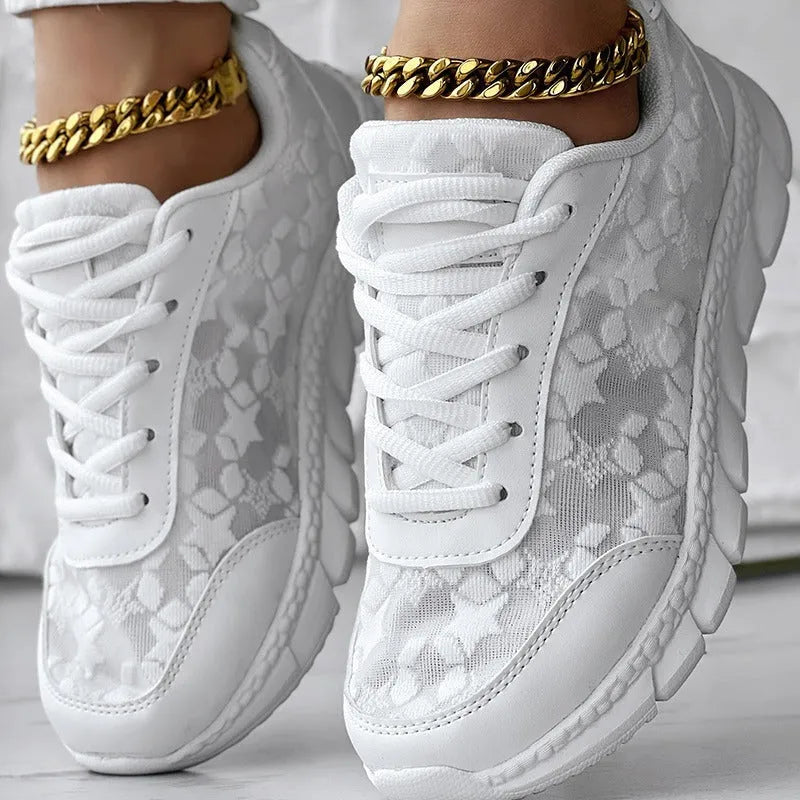 Women's white canvas casual sports running shoe with round toe and flat heel on a neutral background.