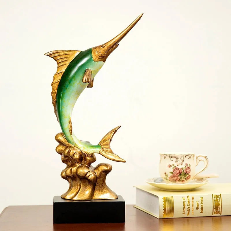 Close-up of a detailed resin European swordfish ornament in bright gold colour on a shelf.