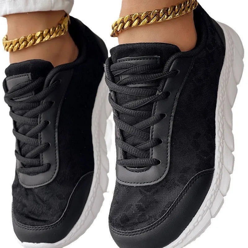 Women's white canvas casual sports running shoe with round toe and flat heel on a neutral background.