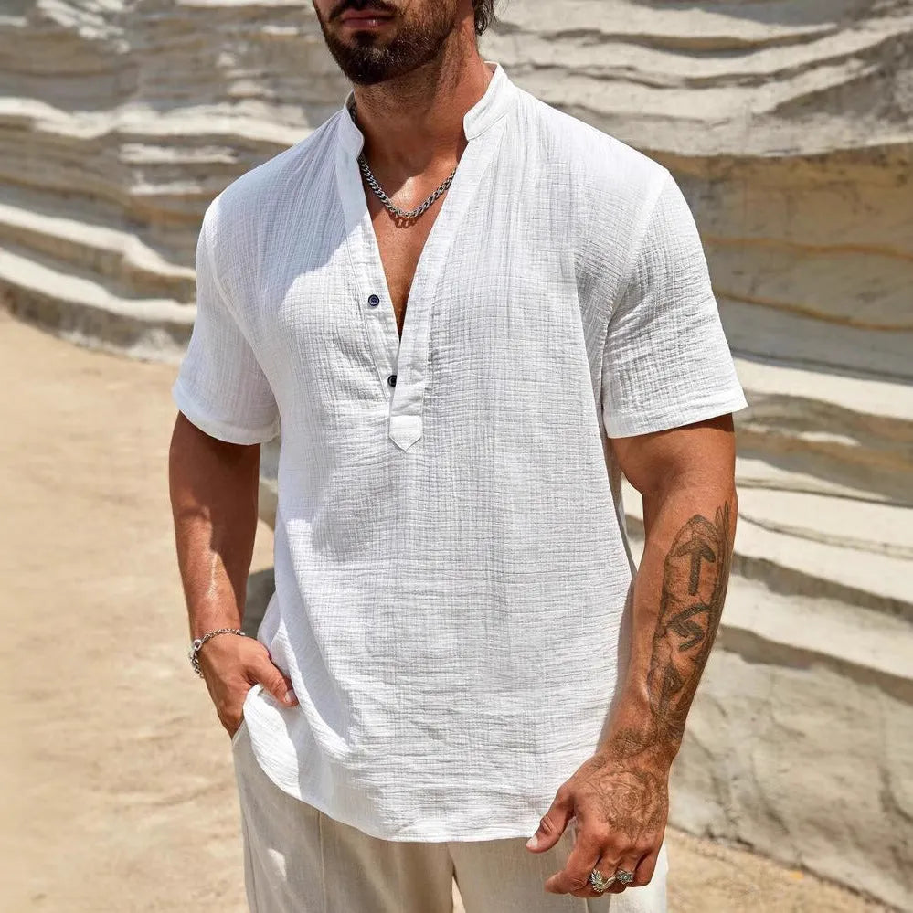 Men's solid colour stand collar short-sleeved casual shirt laid flat, showing slit detail and thin fabric.