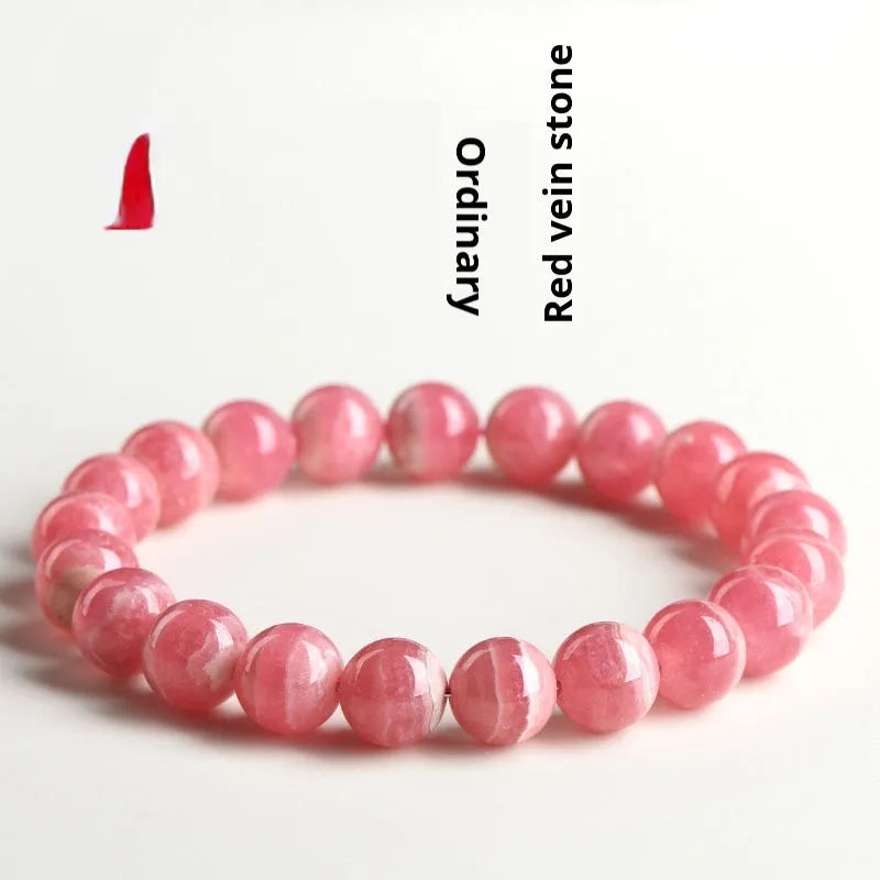 Women's red rhodochrosite crystal bracelet with geometric pattern and longevity lock clasp showing natural stone variations