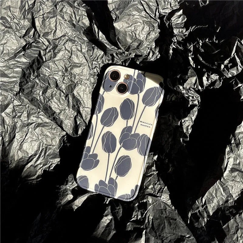 Black silicone iPhone case with a detailed tulip flower print on the back.