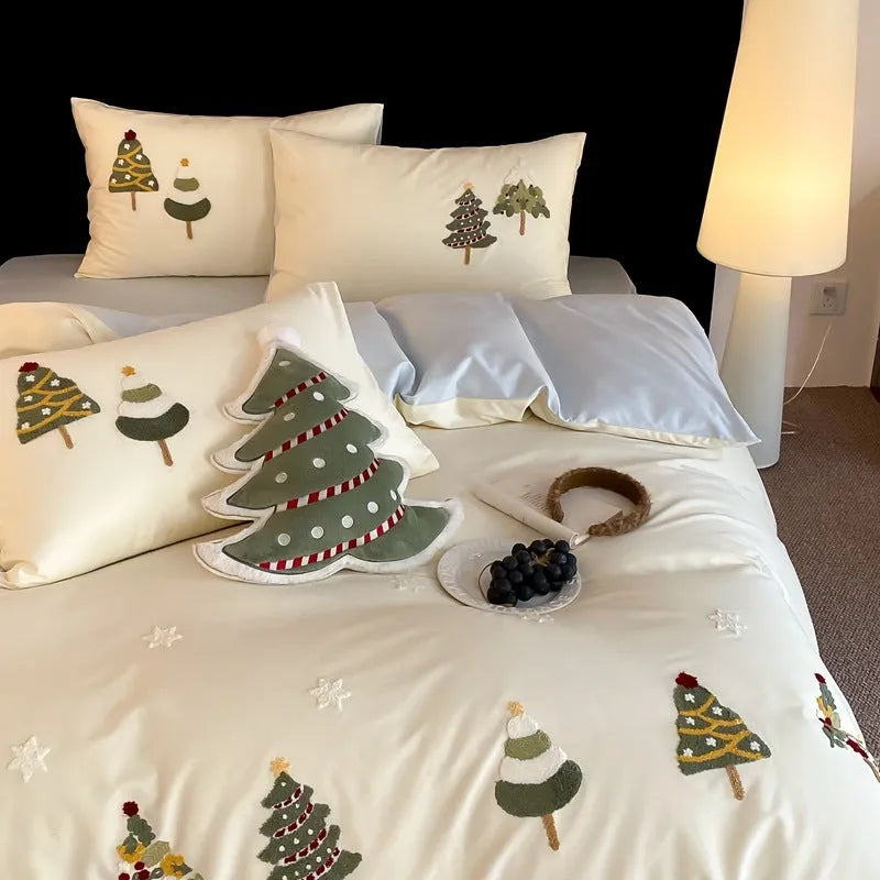 Four-piece cotton bedding set with Christmas tree towel embroidery pattern showing duvet cover, bed sheet, and pillowcases