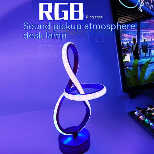 Black musical note shaped Bluetooth light with remote control on a bedside table.