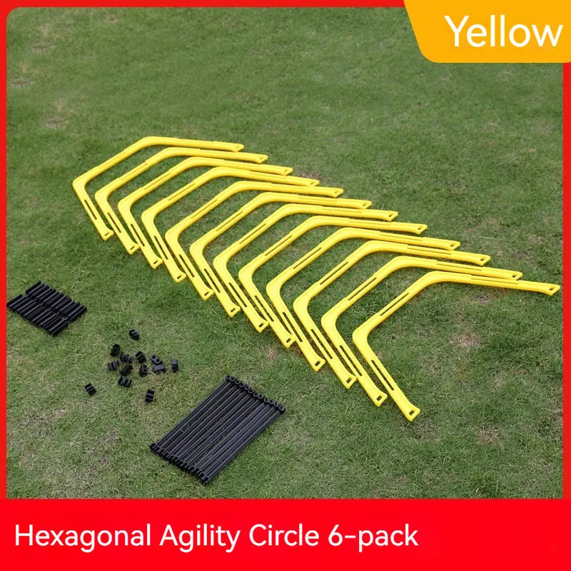 Set of six foldable yellow green and orange hexagon football agility training rings on grass.